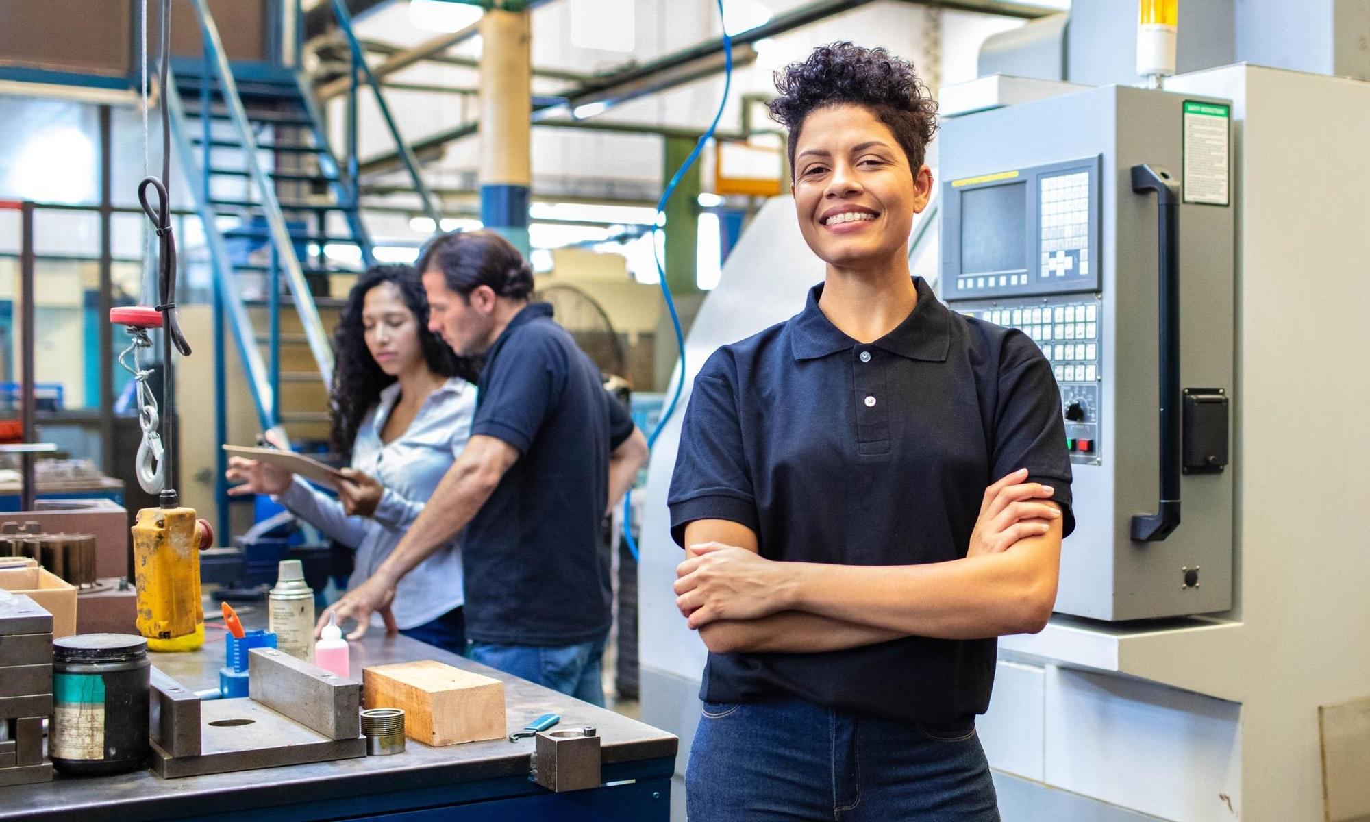 Female engineer standing in manufacturing company